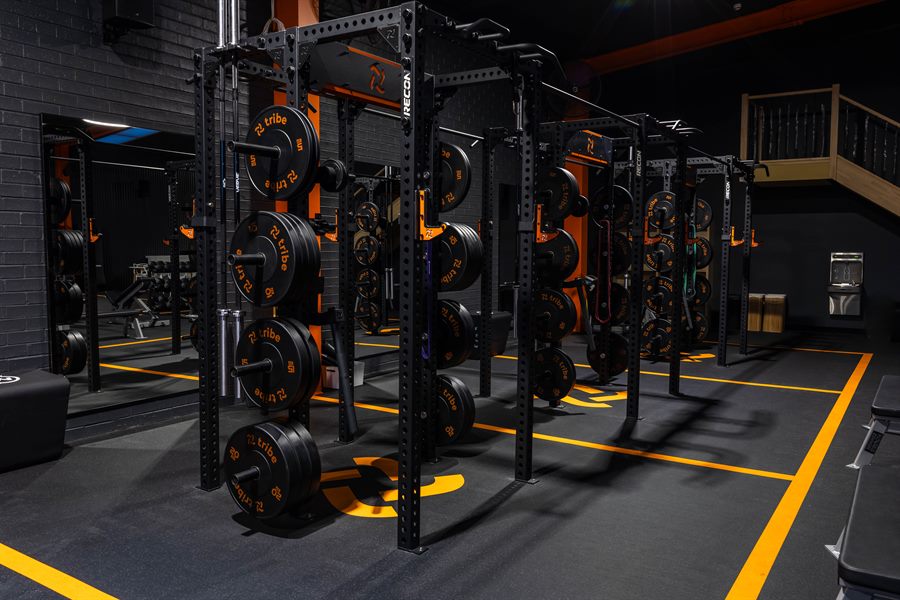 RECON gym fitout with loaded racks and branded flooring